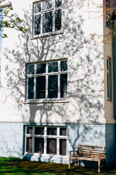istock A new modern white multi-storey building with large windows and a bench against the wall. 1276633229