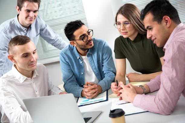 istock Multy-ethnic group of young business people working with computer at office 1276633653