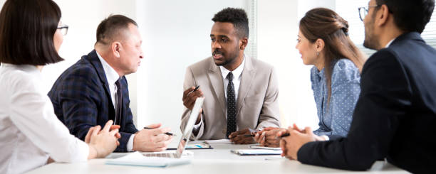 istock Multy-ethnic group of young business people working with computer at office 1276634533
