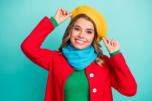 Portrait of nice pretty lovely candid girl enjoy winter season rest relax holiday, touch hand headwear wear good look clothes isolated over teal color background