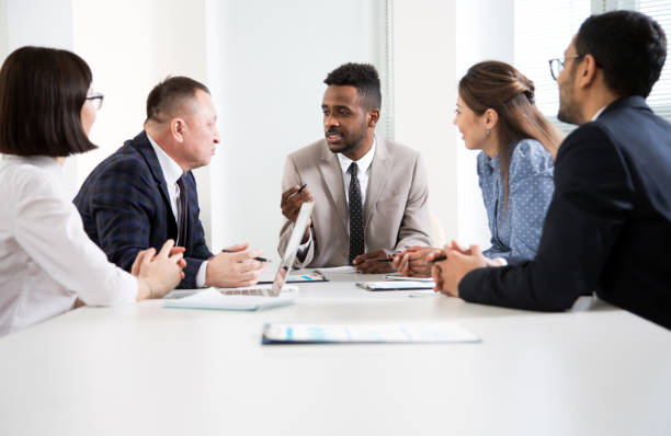 istock Multy-ethnic group of young business people working with computer at office 1276636579
