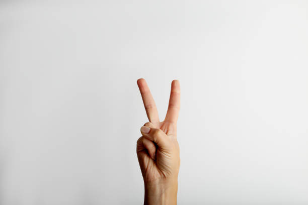 istock Female hand shows victory gesture, on white background with free space for text 1276637433