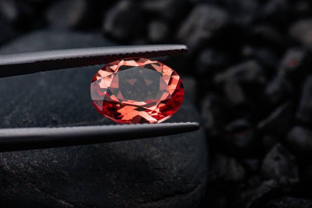 istock Oval red garnet gemstone with dark rock. 1276637936