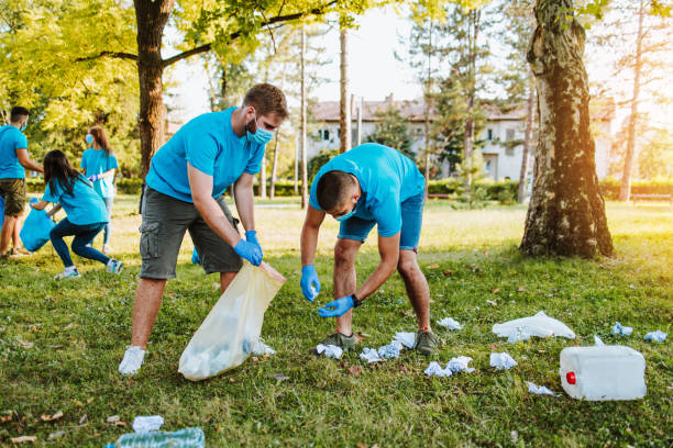 istock Volunteers with garbage bags cleaning up garbage outdoors - ecology concept. 1276638094