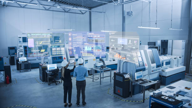 industry 4.0 factory: two engineers uses digital tablet computer with augmented reality software to connect with high-tech machinery, robot arm and visualize maintenance and diagnostics of equipment - analytical instruments imagens e fotografias de stock