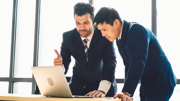 istock Two business people talk project strategy at office 1276639180