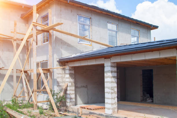 istock facade of cottage under construction covered with plaster with new windows inserted 1276639395