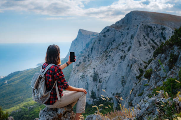istock woman hiker enjoy the view at sunset mountain peak cliff 1276641332