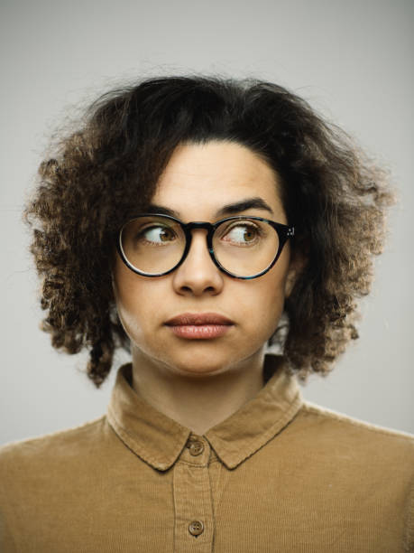 istock Studio portrait of young woman with blank expression looking to the side. 1276642552