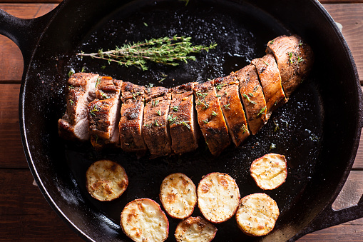 Pork Tenderloin with Roasted Potatoes and Thyme in a Cast Iron Skillet