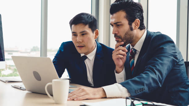 istock Two business people talk project strategy at office 1276644963