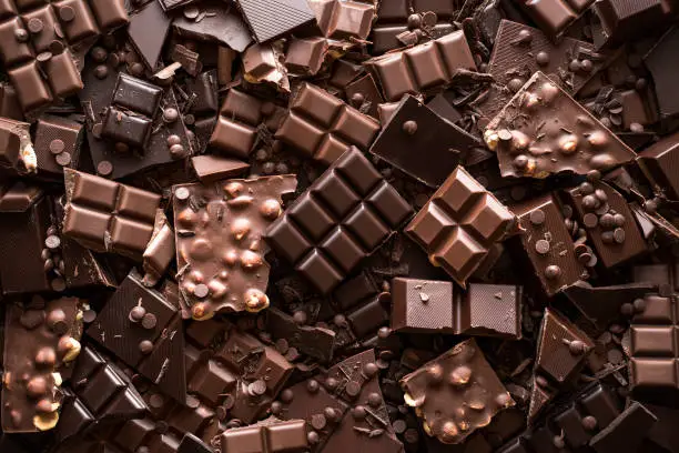 Photo of Chocolate assortment background. Top view of different kinds of chocolate