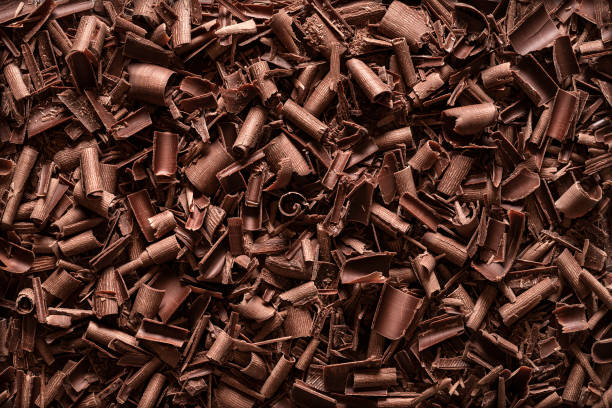 Chocolate pieces background. Top view of chocolate shavings stock photo