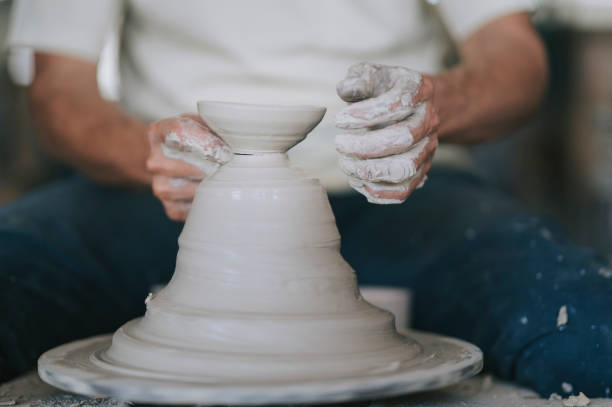 istock asian chinese active senior man Potter working at his workshop with spinning pottery wheel 1276650706