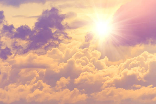 istock Sun with bright warm rays through dense clouds divine radiance of the sky. 1276651165