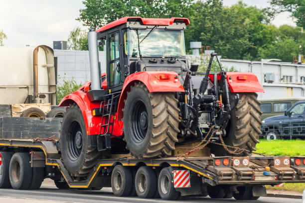 large red tractor on trailer