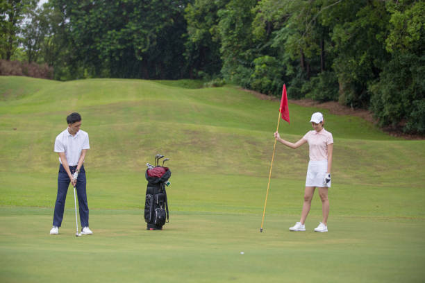 istock Chinese mature guy tee off swing his driver club at tee off point golf course in weekend 1276652124