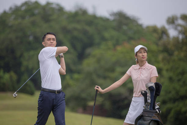 istock Asia Chinese man playing golf tee off while his partner watching. 1276652213