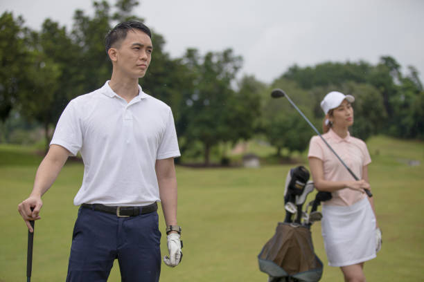istock Asia Chinese man playing golf tee off while his partner watching. 1276652259