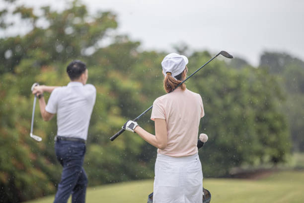 istock Asia Chinese man playing golf tee off while his partner watching. 1276652264