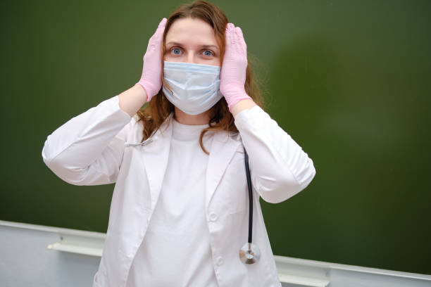 scared doctor in medical mask in school class. concept of problems at school during the coronavirus epidemic - pensive question mark teenager adversity imagens e fotografias de stock