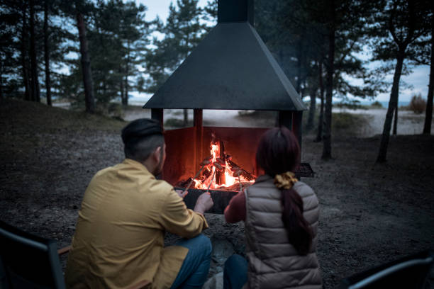 Happy family cooking on bonfire