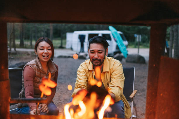 Happy family cooking on bonfire