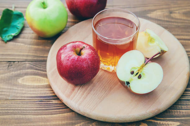 istock Apple juice in a glass. Selective focus. 1276654871