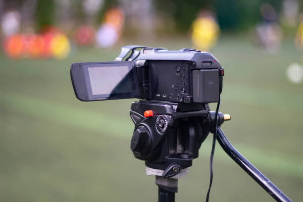 istock Camcorder on a tripod. Shooting outdoors. 1276655047