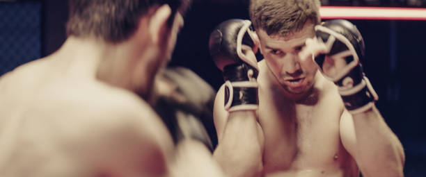 istock MMA fighters training. Eye contact and punches. Close up on face 1276655180