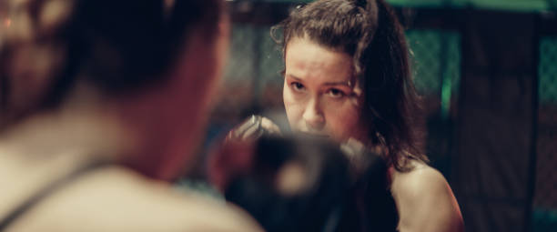 istock Female MMA fighters training. Eye contact before first punch 1276655221