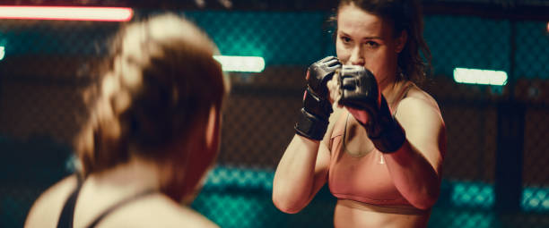 istock Female MMA fighters training. Eye contact before first punch 1276655252