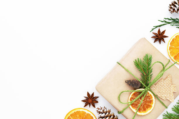 istock Zero waste christmas layout with craft gift, fir tree, thuja, dry orange, pine cones, star anise, on white background. 1276656249