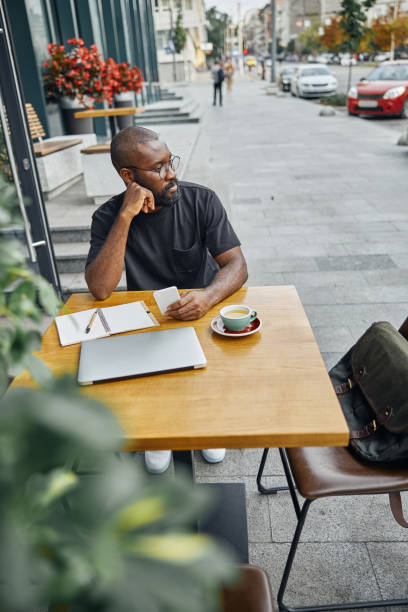 istock Thoughtful person relaxing in the cafe outdoors alone 1276656349