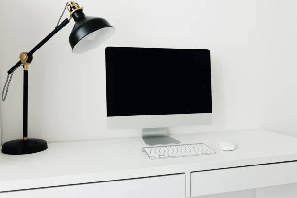 istock White desktop with black monitor and desk lamp. Workplace concept. Mockup blank computer screen with keyboard. Minimalism in the interior. Student desktop. 1276657560