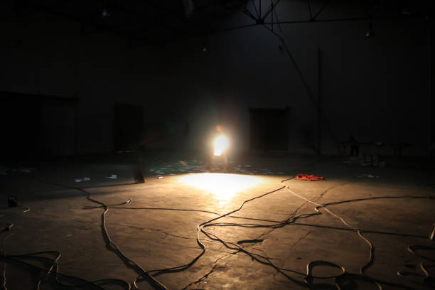 istock Comedian holding a spotlight on a theater stage 1276657812