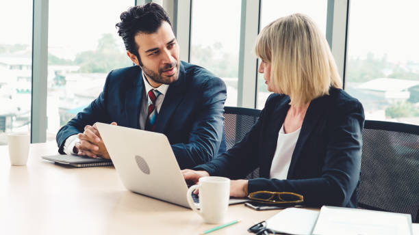istock Two business people talk project strategy at office 1276658909