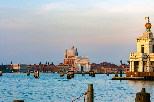 We are looking across the Venetian Lagoon just after dawn toward the facade of the Benedictine church and the San Giorgio Maggiore island of the same name.