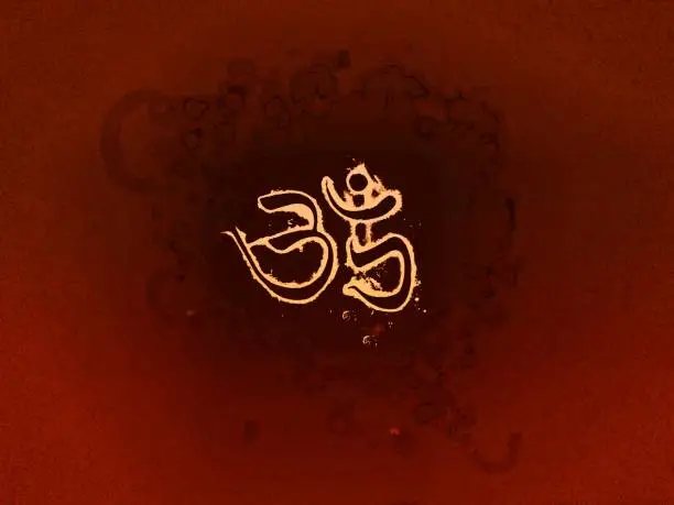 Photo of Om symbol text on saffron abstract background
