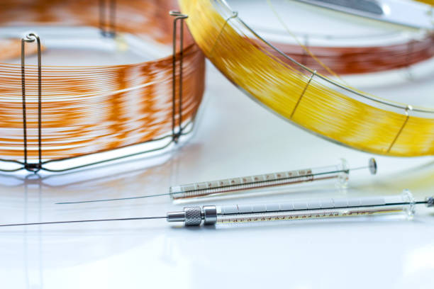 capillary columns of different lengths for gas chromatographic analysis and glass syringes for sample insertion. capillary columns of different lengths for gas chromatographic analysis and glass syringes for sample insertion. equipment for analytical chemistry in the laboratory. chromatography stock pictures, royalty-free photos & images