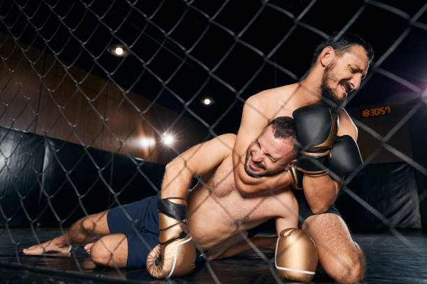 istock Boxing champion on his knees choking his opponent 1276661358