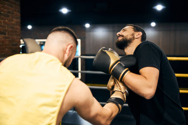 istock Boxer hitting his sparring partner with an uppercut 1276661420