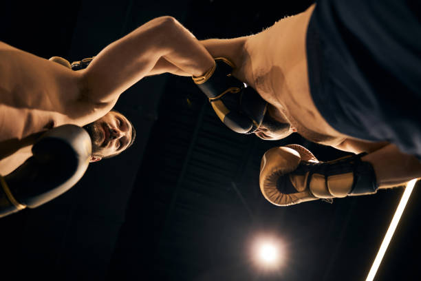 istock Two boxers without shirts exchanging blows in the ring 1276661436