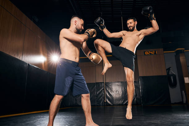 istock Boxer jumping and hitting the opponent with his leg 1276661475
