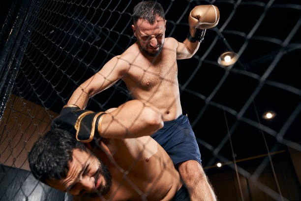istock Muscular man covering his head under punches 1276661478