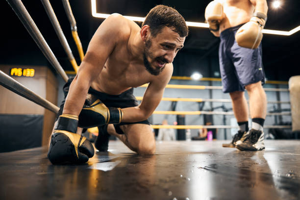 istock Hopeless male boxer is kneeling in the ring 1276661495
