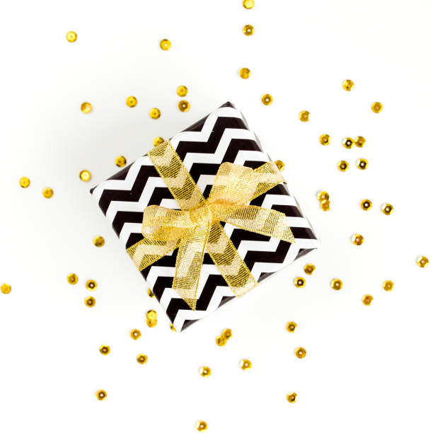istock Gift or present box and stars confetti on a white background. Colorful celebration, birthday. Christmas or New Year pattern. Flat lay, top view 1276661629