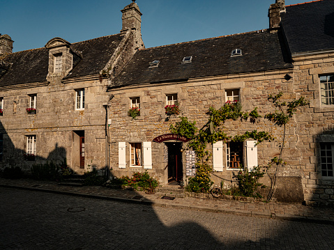 Locronan, France : September 11, 2020 Souvenir shop in old stone building in Locronan  Brittany France It is considered as one of the most beautiful villages in this country. It is  an old town of the XVI century.