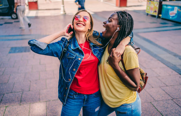 istock Two multi-ethnic women friends sharing music 1276662554