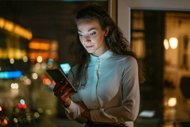 istock Young woman using smart phone at night. 1276663931